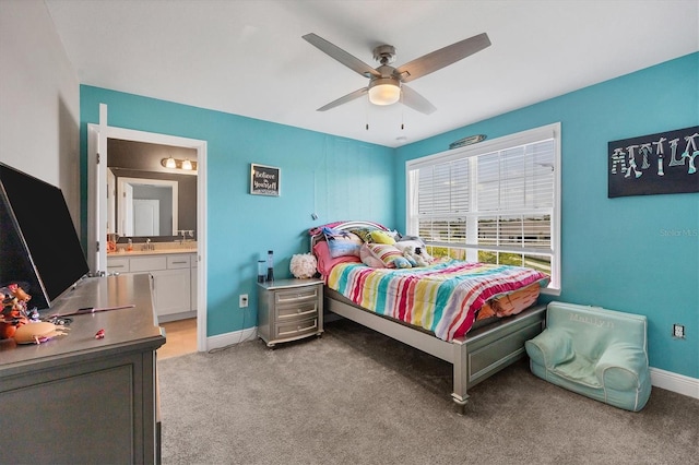 carpeted bedroom featuring ensuite bath and ceiling fan