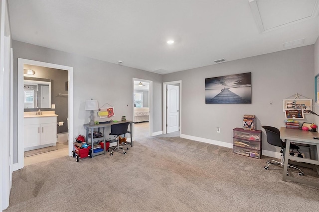 office space featuring light carpet, a healthy amount of sunlight, and sink