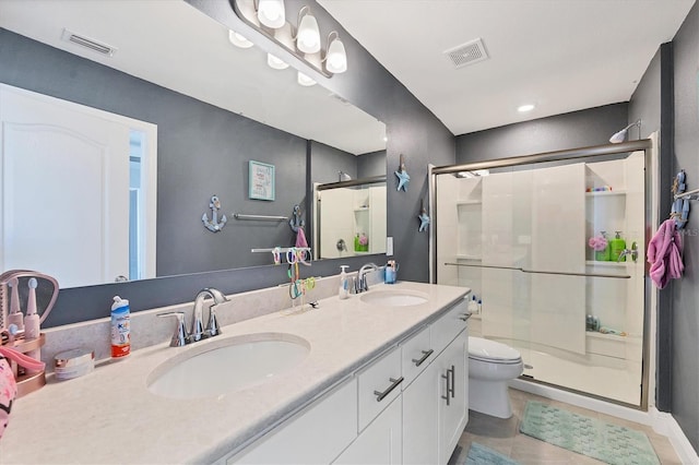 bathroom with toilet, vanity, tile patterned floors, and a shower with door