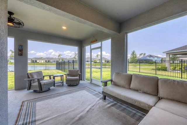 sunroom with a water view and beamed ceiling