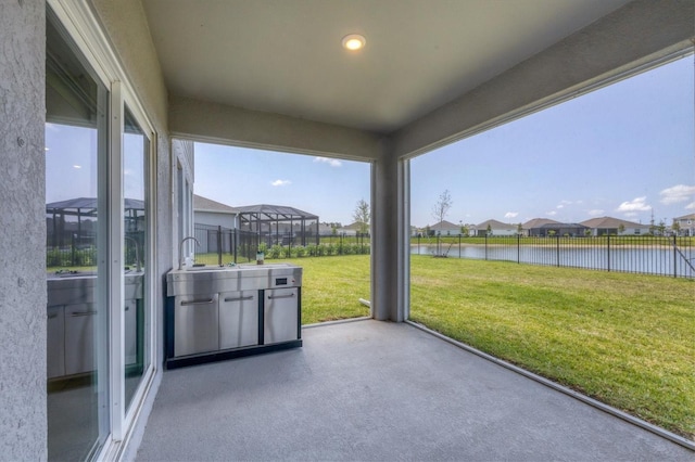 unfurnished sunroom featuring a water view and plenty of natural light