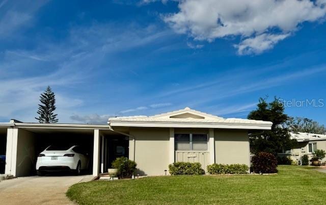 view of property exterior featuring a lawn and a carport