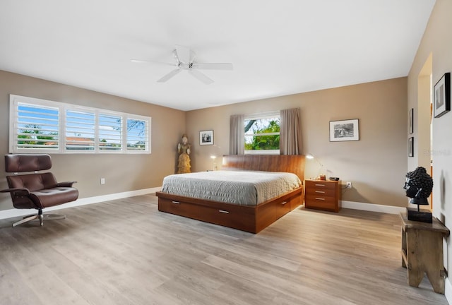 bedroom with ceiling fan and light hardwood / wood-style flooring