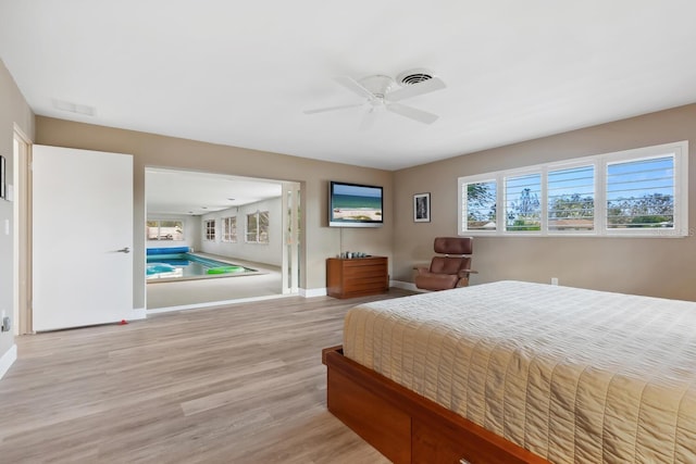 bedroom with light hardwood / wood-style flooring and ceiling fan