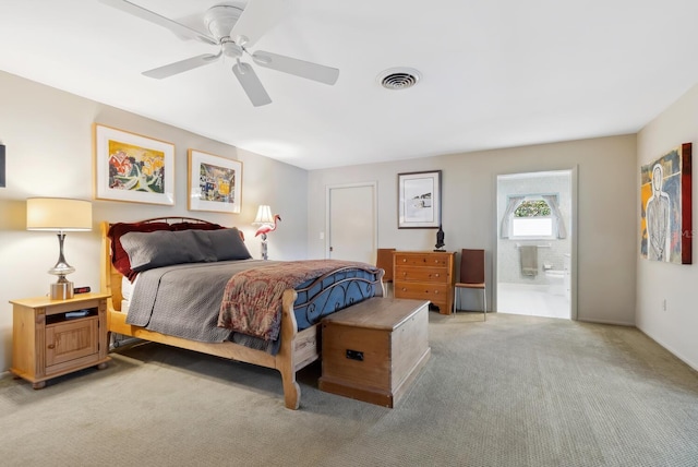 bedroom with ensuite bathroom, carpet, and ceiling fan