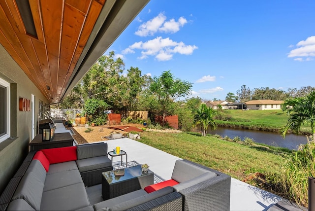 view of patio / terrace with an outdoor living space and a water view