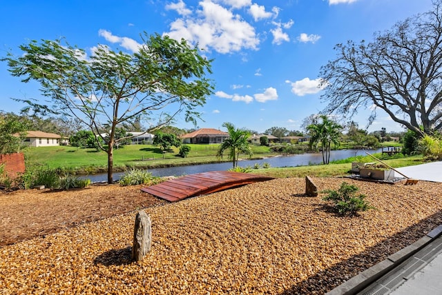 view of home's community with a yard and a water view