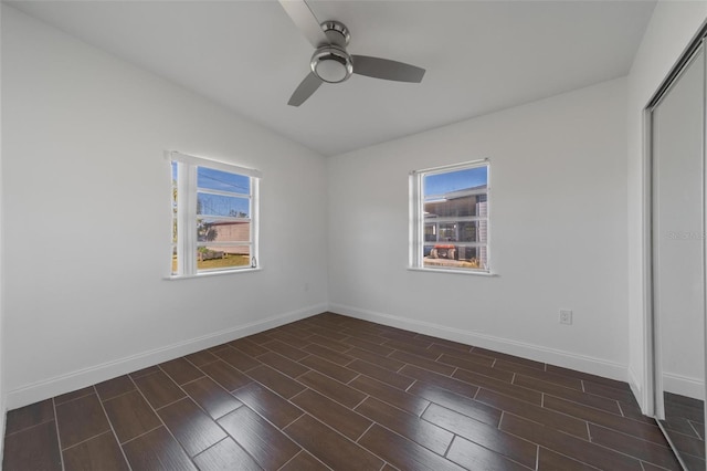 empty room with plenty of natural light, lofted ceiling, and ceiling fan