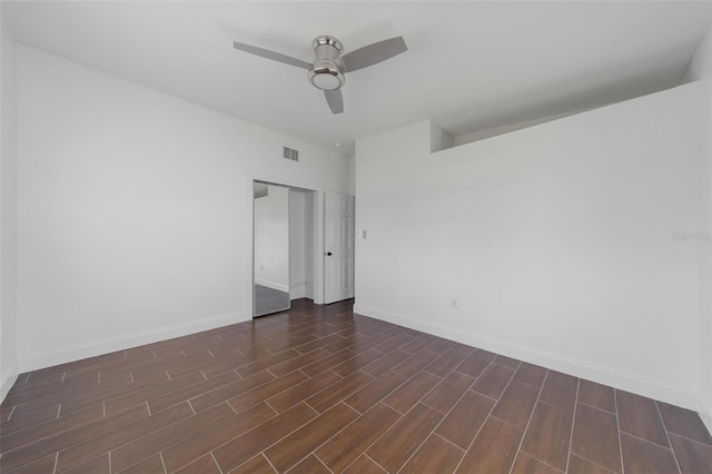 unfurnished room featuring ceiling fan and dark hardwood / wood-style flooring