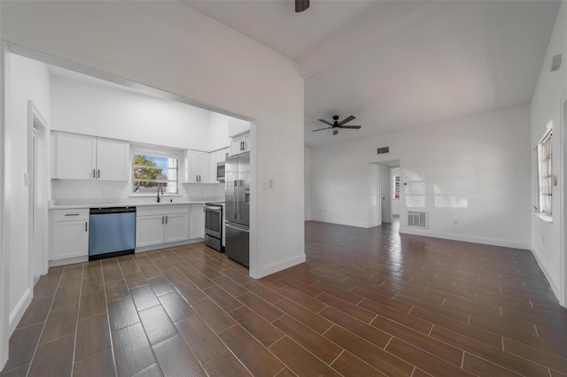 kitchen featuring stainless steel appliances, sink, white cabinets, and ceiling fan