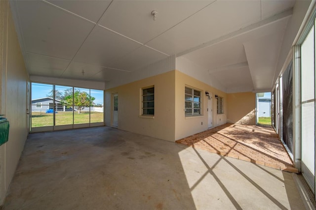 unfurnished sunroom with a water view