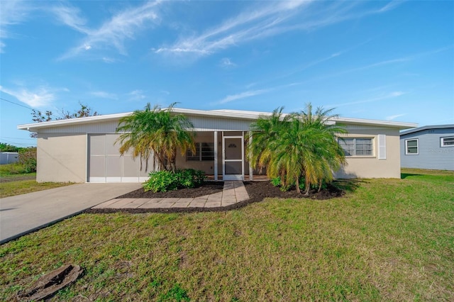 single story home with a garage and a front lawn