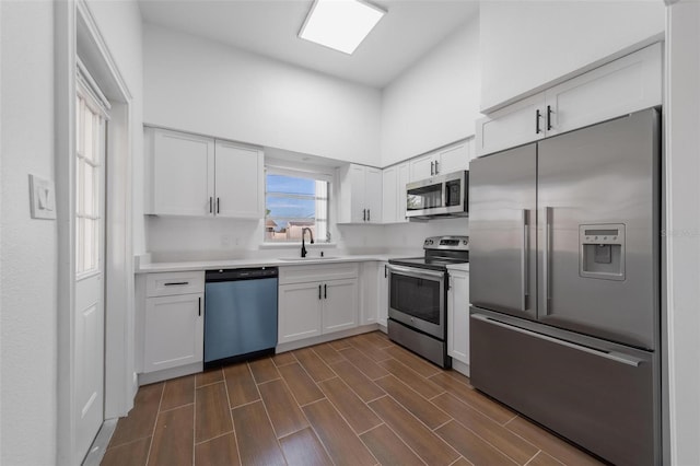 kitchen featuring appliances with stainless steel finishes, sink, and white cabinets