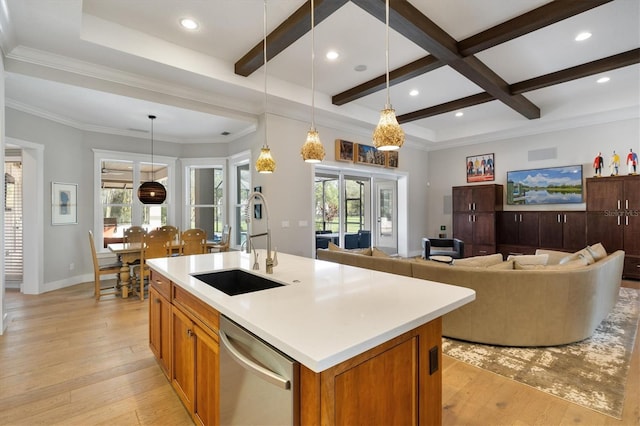 kitchen featuring pendant lighting, dishwasher, sink, beam ceiling, and light hardwood / wood-style floors