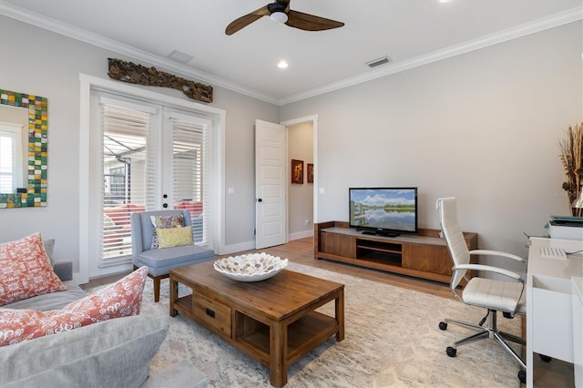 interior space featuring light hardwood / wood-style flooring, ceiling fan, and ornamental molding