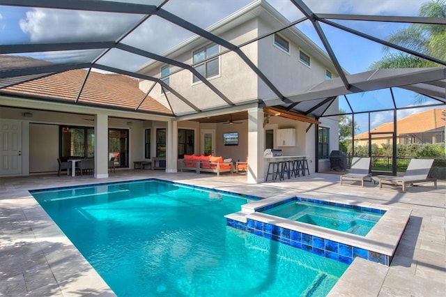 view of pool featuring glass enclosure, ceiling fan, outdoor lounge area, an outdoor bar, and a patio