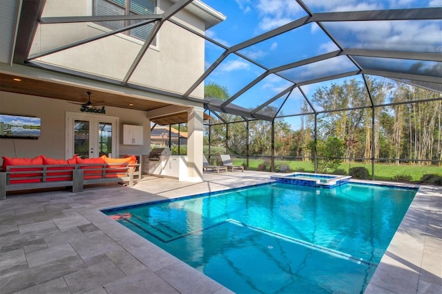 view of swimming pool featuring an in ground hot tub, an outdoor hangout area, ceiling fan, glass enclosure, and a patio