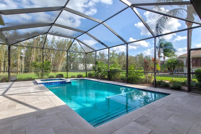 view of swimming pool featuring a patio area, a lanai, and an in ground hot tub