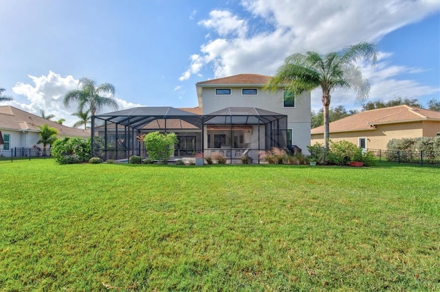 back of house with a yard and a lanai