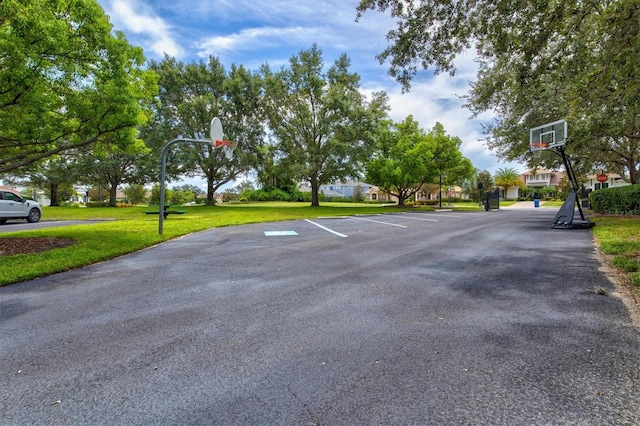 view of basketball court featuring a yard