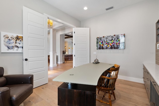 office featuring light wood finished floors, recessed lighting, visible vents, and baseboards