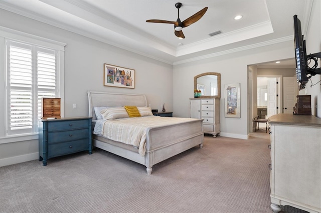 bedroom featuring a raised ceiling, light carpet, crown molding, and visible vents