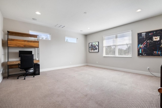 home office featuring a wealth of natural light, light carpet, and baseboards