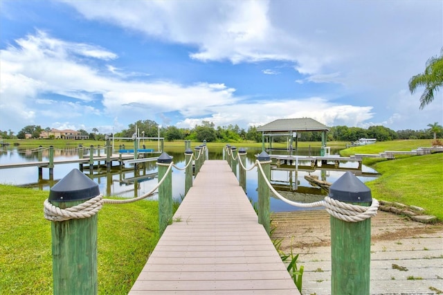 dock area featuring a water view, a yard, and boat lift