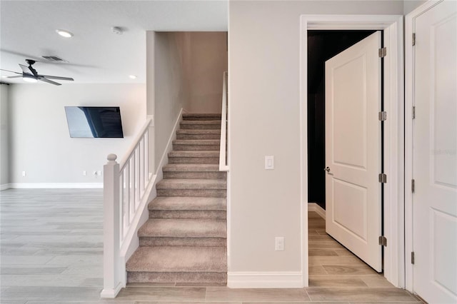 stairway with ceiling fan