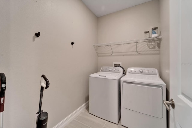 laundry area featuring independent washer and dryer and light tile patterned floors