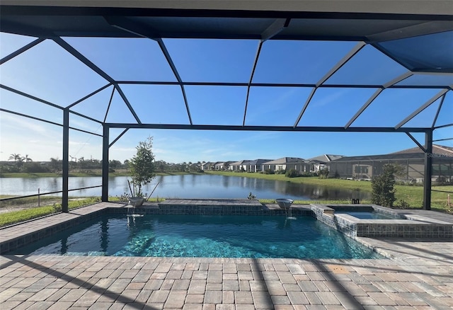 view of pool with an in ground hot tub, pool water feature, a water view, and glass enclosure