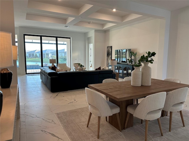 dining room featuring beamed ceiling and coffered ceiling