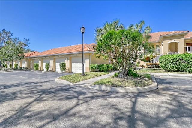 mediterranean / spanish-style house with a garage