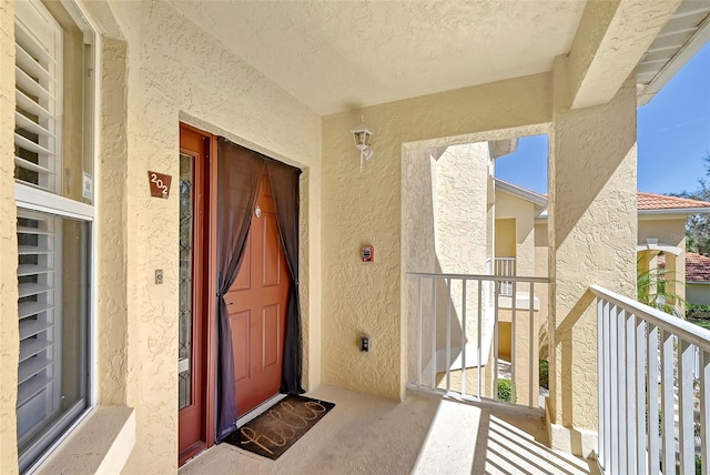 entrance to property featuring a balcony