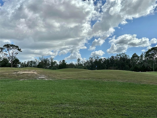 surrounding community with a lawn and golf course view