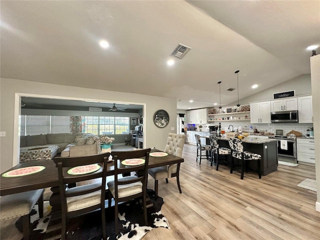 dining room with light wood finished floors, recessed lighting, ceiling fan, visible vents, and lofted ceiling