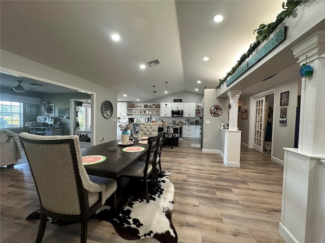 dining space with recessed lighting, ornate columns, light wood-style floors, vaulted ceiling, and visible vents
