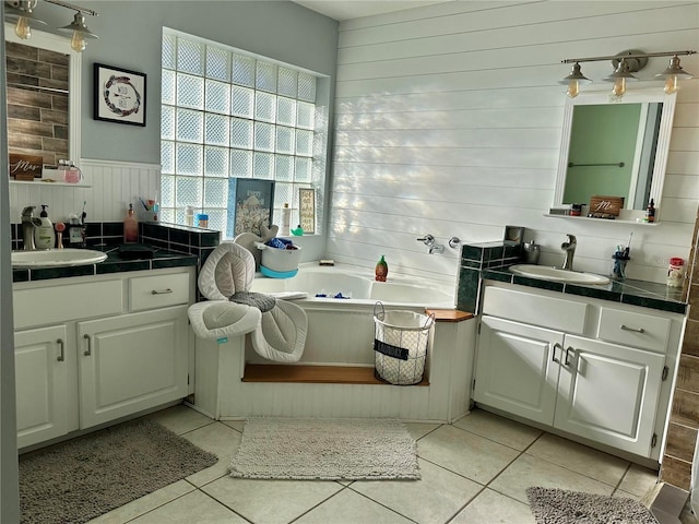 full bathroom featuring two vanities, tile patterned flooring, and a sink