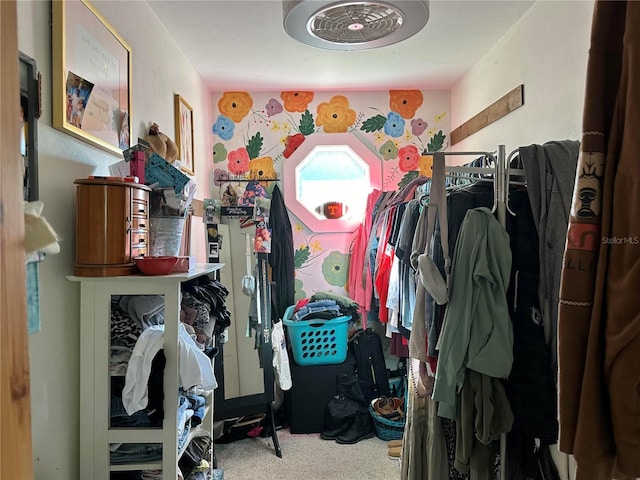 walk in closet featuring carpet flooring