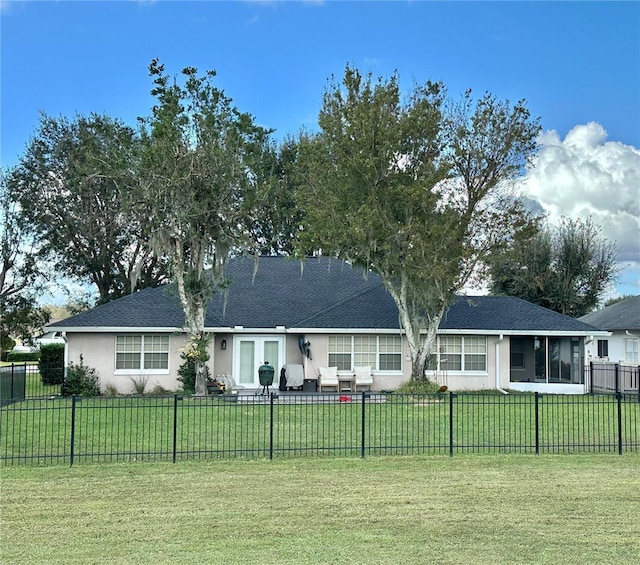 view of front of home featuring a front yard, fence private yard, and stucco siding