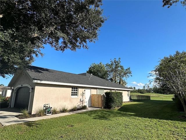 ranch-style house with a front lawn, a garage, stucco siding, and fence