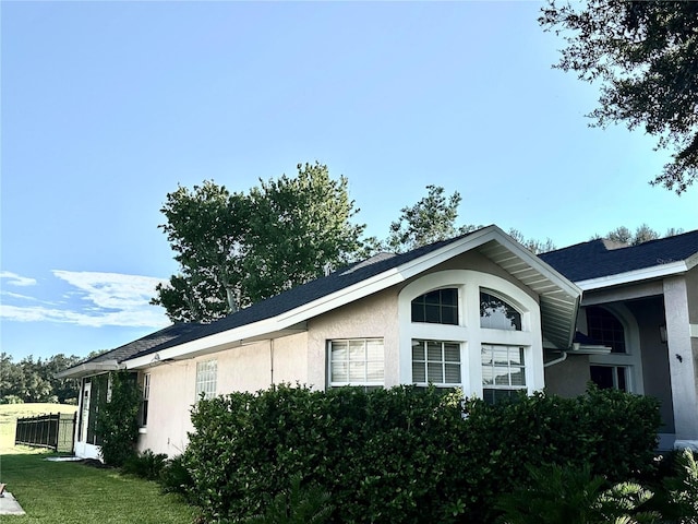 view of property exterior with a yard and stucco siding