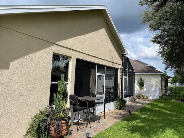 back of house with a patio and a lawn