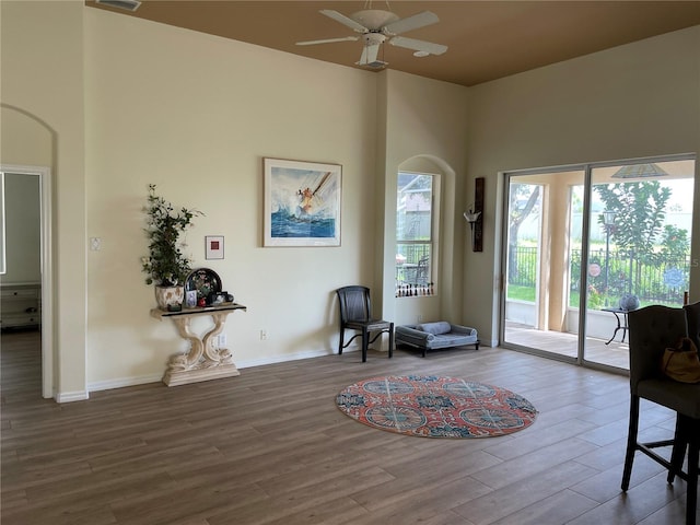 sitting room with wood-type flooring and ceiling fan