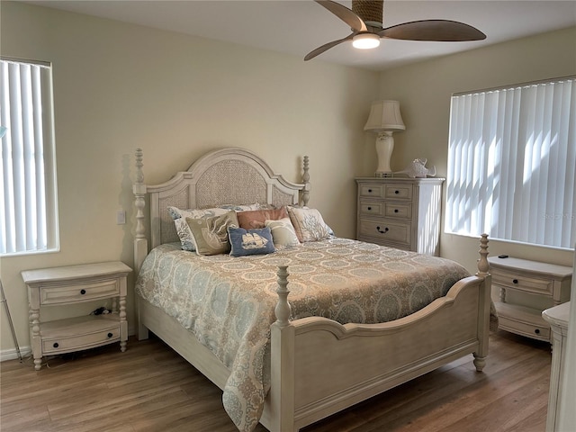 bedroom with wood-type flooring and ceiling fan