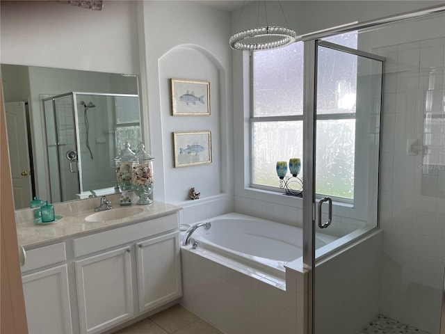 bathroom with vanity, an inviting chandelier, shower with separate bathtub, and tile patterned floors