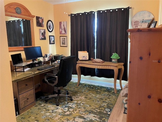 office space featuring hardwood / wood-style floors and built in desk