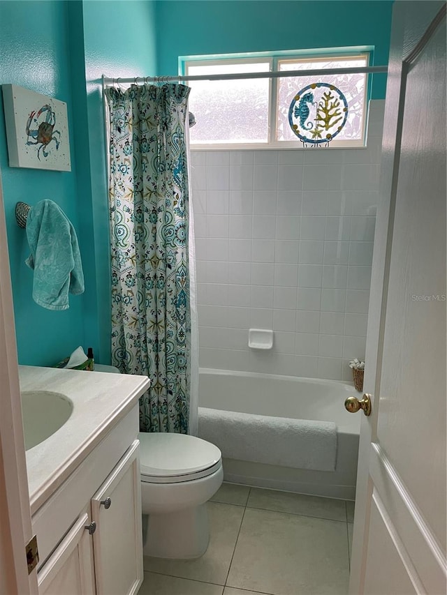 full bathroom with vanity, toilet, tile patterned floors, and a wealth of natural light