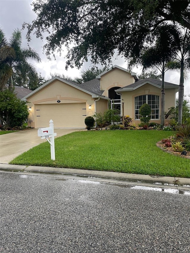 view of front of property featuring a front lawn and a garage