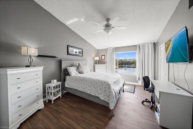 bedroom featuring vaulted ceiling, ceiling fan, a textured ceiling, and dark hardwood / wood-style flooring